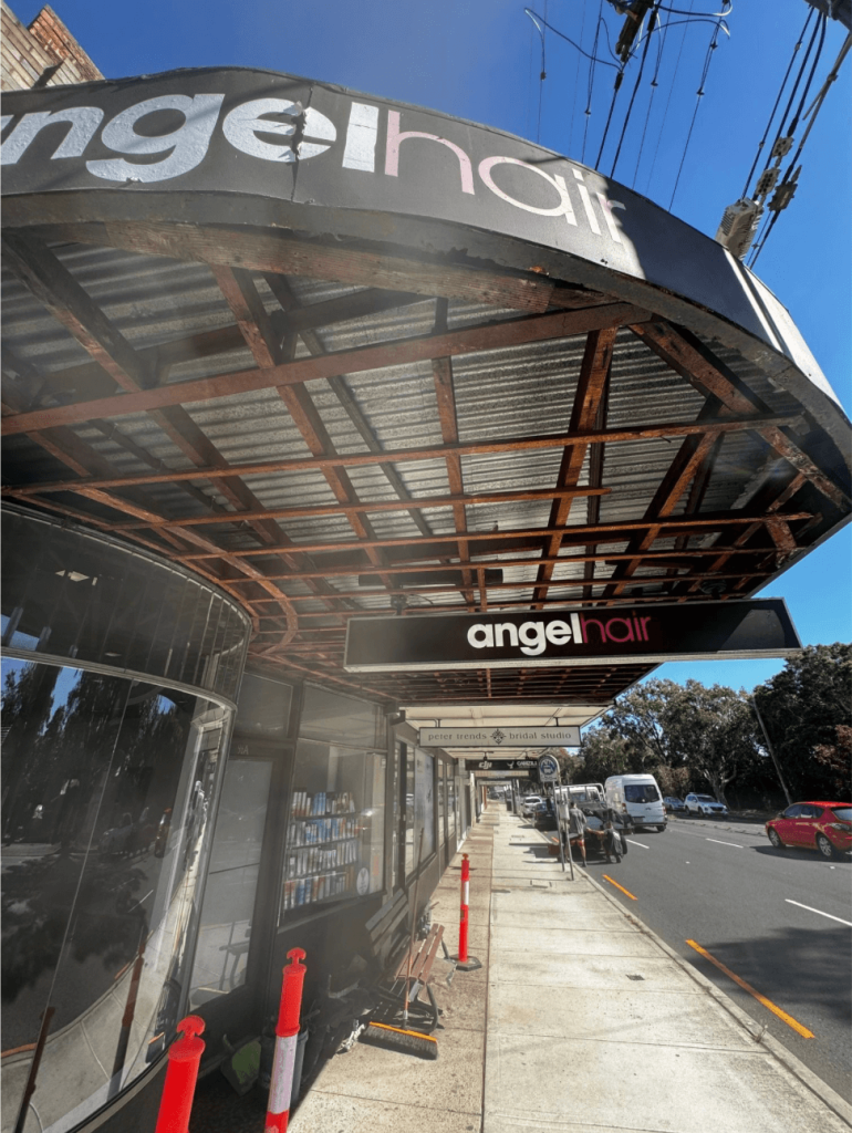 Rusted and corroded awning frame on a Roseville shopfront before repair