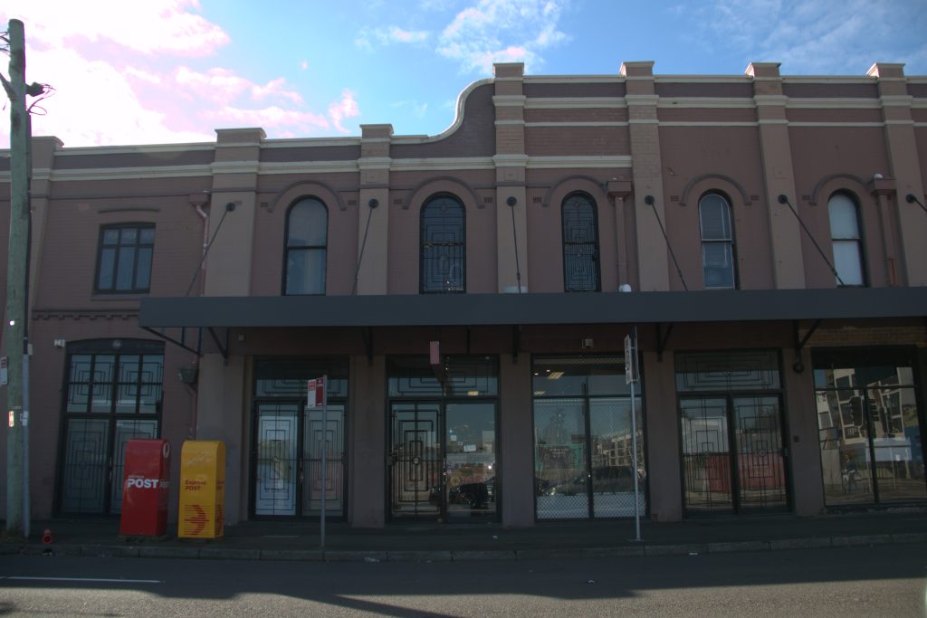 Close-up view of the heritage brick building and awning in Camperdown