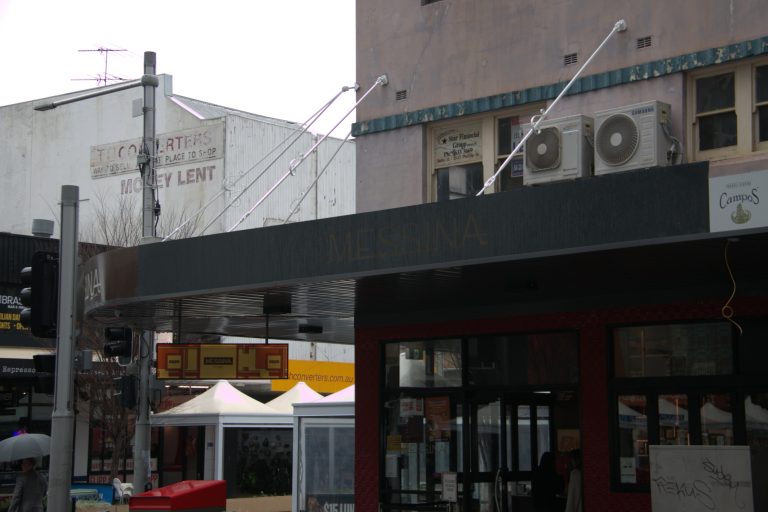 Wraparound corner retail awning with tie rods at Gelato Messina, Church Street, Parramatta
