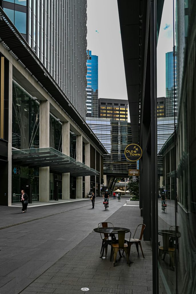 Outdoor café seating on a quiet Barangaroo street in the Sydney CBD, with modern building canopies overhead