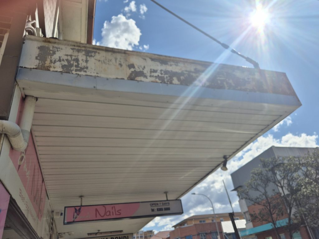 Corroded and peeling shop awning fascia