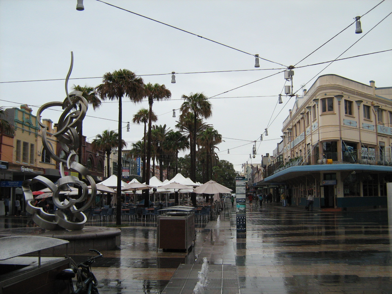 Heritage building with a curved verandah awning wrapping the corner of The Corso and Sydney Road, Manly