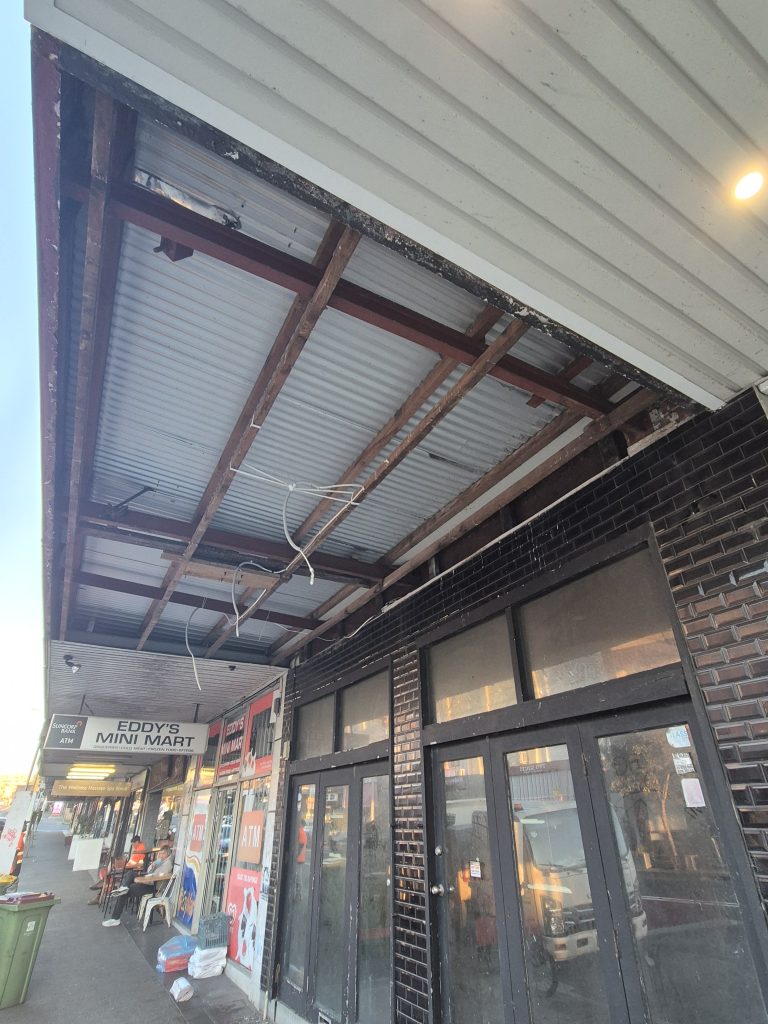 Street awning on Bondi Road stripped back to the steel frame and roof sheeting during repairs